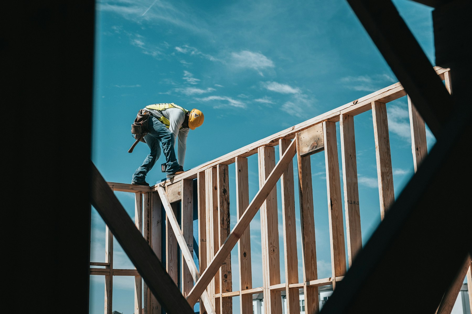 Builder on site fixing a timber frame
