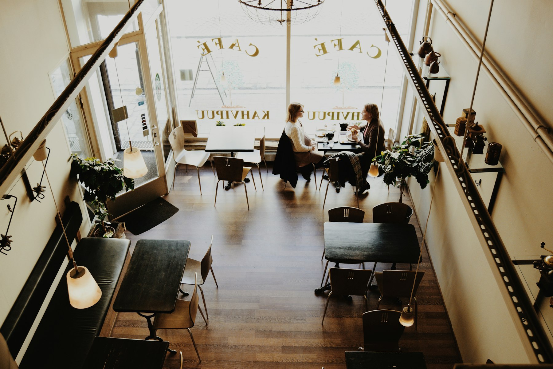 Two people chatting at a small cafe table