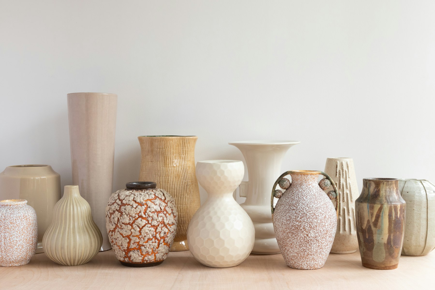 Handmade ceramic cups and bowls on a shelf