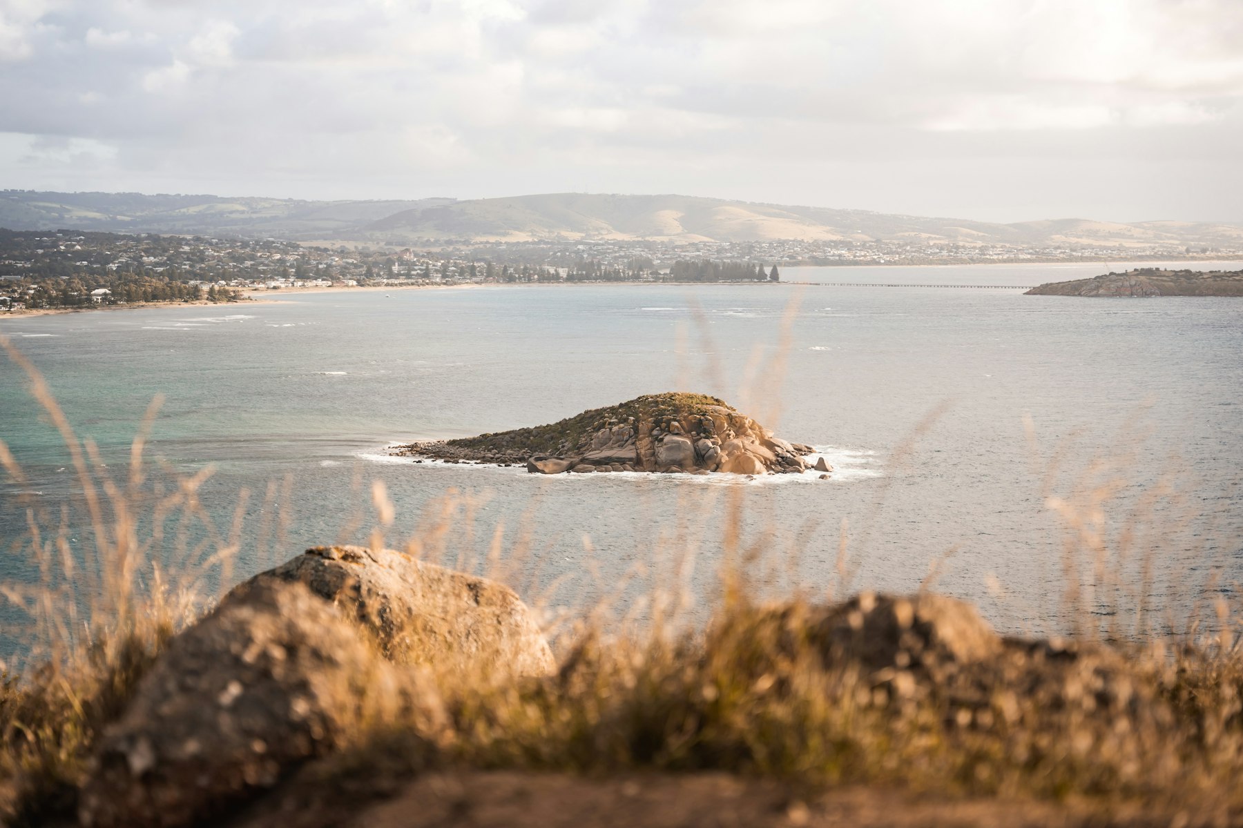 Granite Island sitting in calm water off Victor Harbor