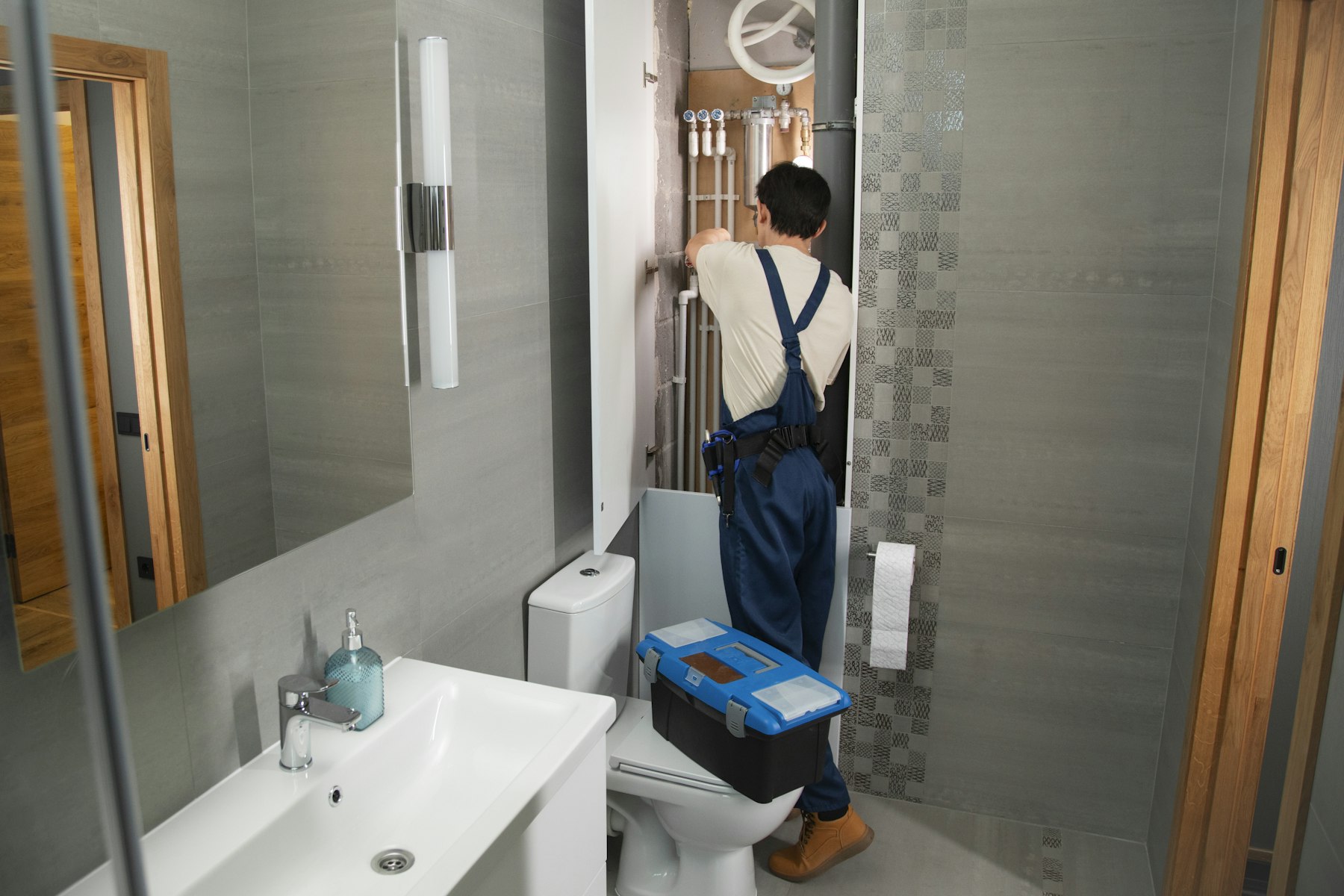 Tradesperson working under a kitchen sink