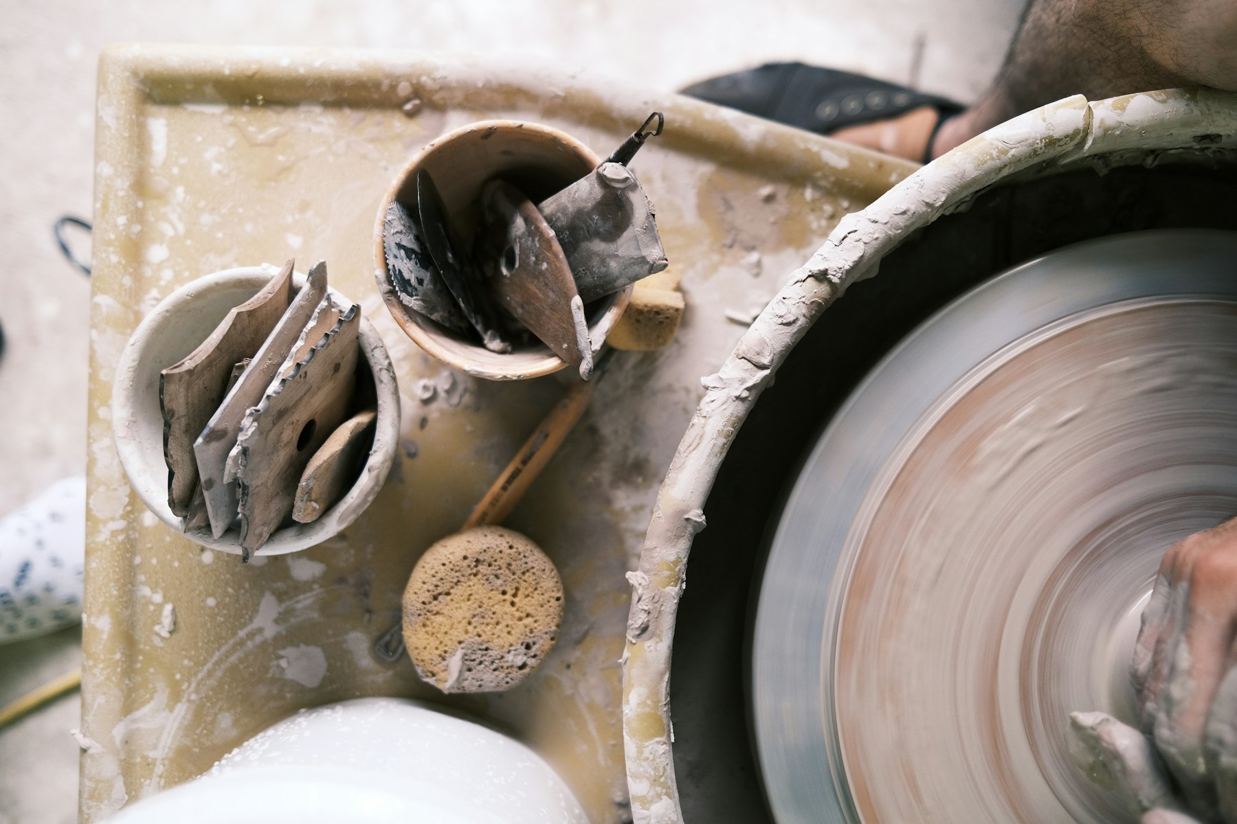 Potter shaping clay on a wheel