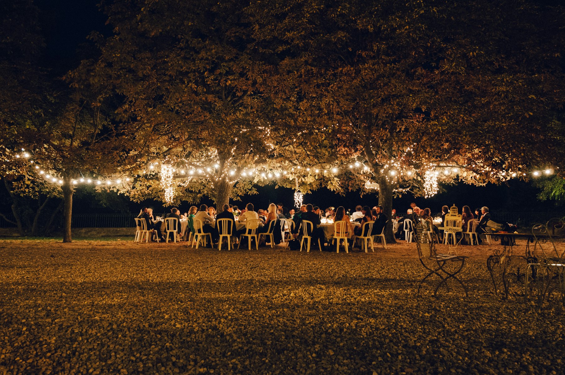 Festoon lights strung over an evening reception