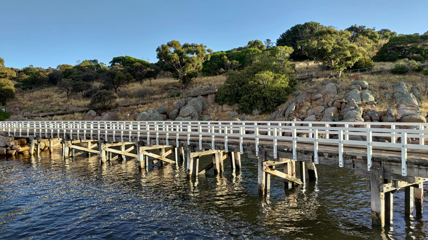 Bridge crossing calm water towards an island